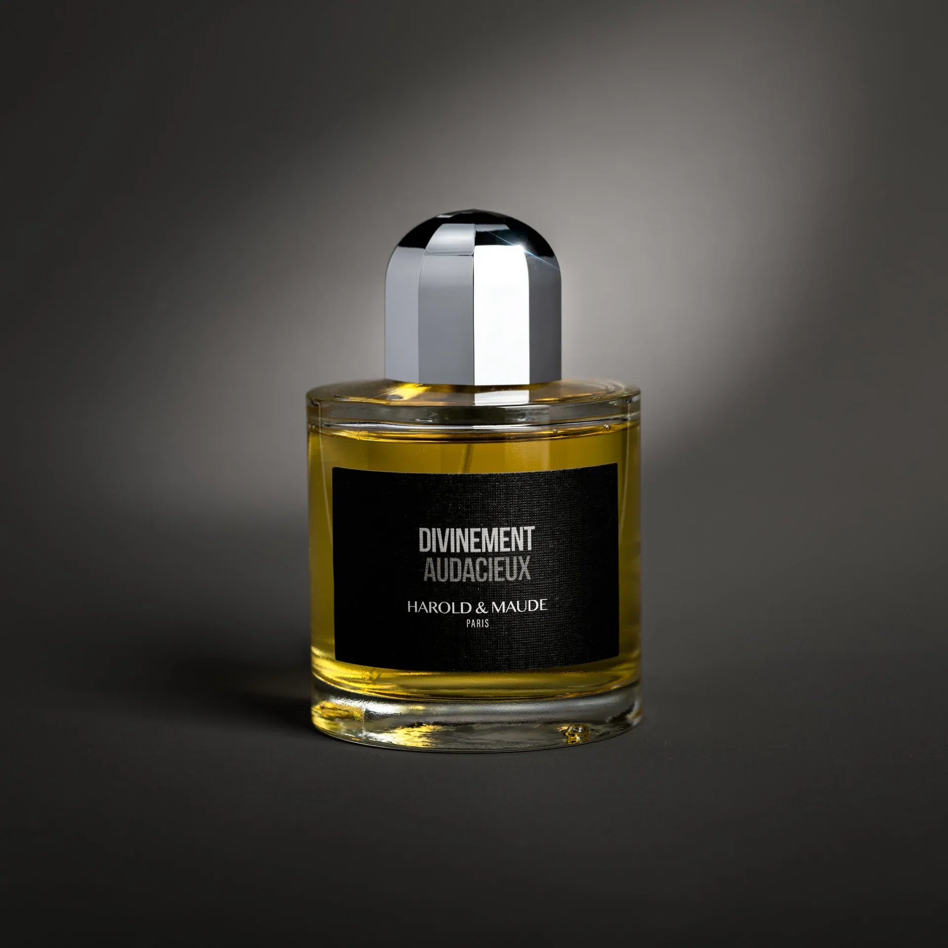 Flacon du parfum de niche Divinement Audacieux de Harold & Maude — parfum floral-épicé boisé, mêlant anis vert, mandarine et bergamote en tête, cœur sensuel de rose, iris, jasmin, fleur d’oranger, cardamome et noix de coco, sur un fond cuir, ambre et bois précieux.